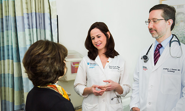 Doctors at the Corrigan Minehan Heart Center meet with a patient Doctors at the Corrigan Minehan Heart Center meet with a patient